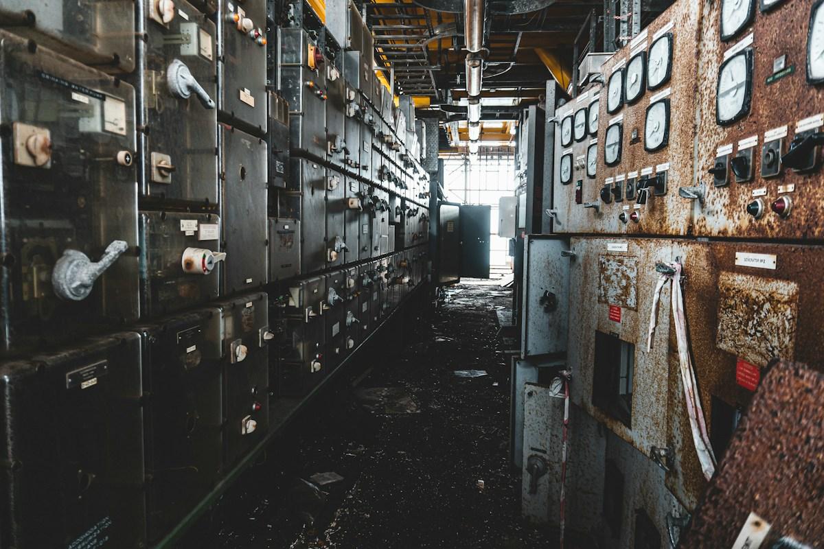 Corridor between rows of control and switchgear panels with gauges